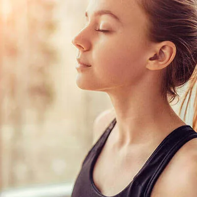 Woman practicing a mindfulness exercise she learned in anxiety therapy near West Hills