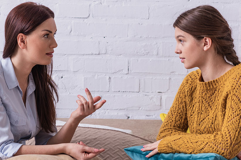 Mother and daughter talking to one another post divorce