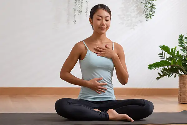 Woman practicing mindfulness exercises for stress relief, focus, and well-being.